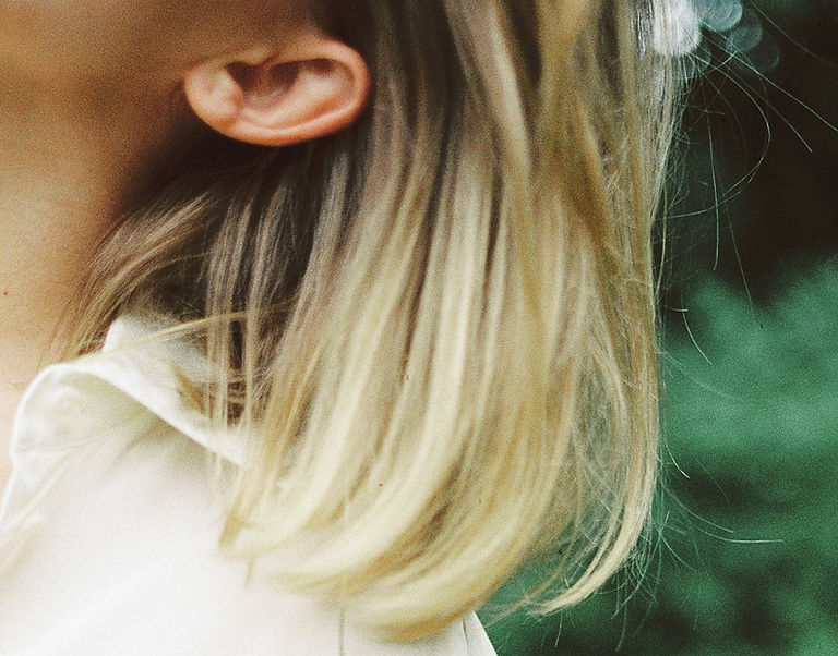 Close-up of hair and shoulder, a quiet moment of stillness